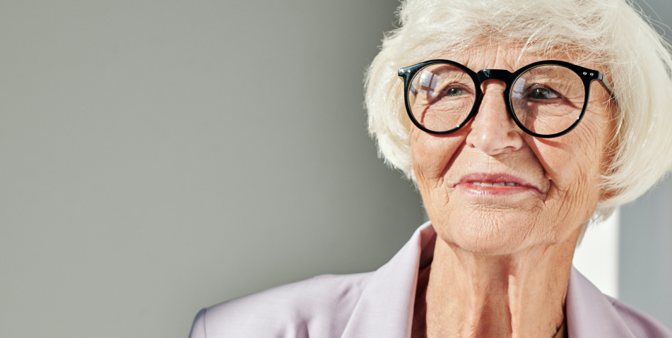 Older woman smiling and wearing glasses