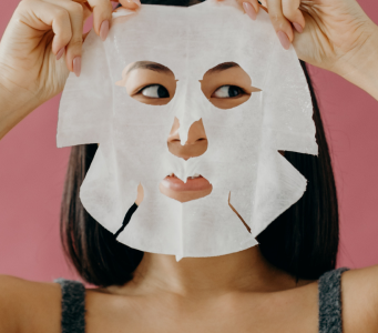 Woman applying sheet mask
