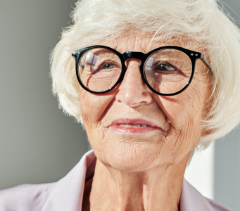 Older woman smiling and wearing glasses